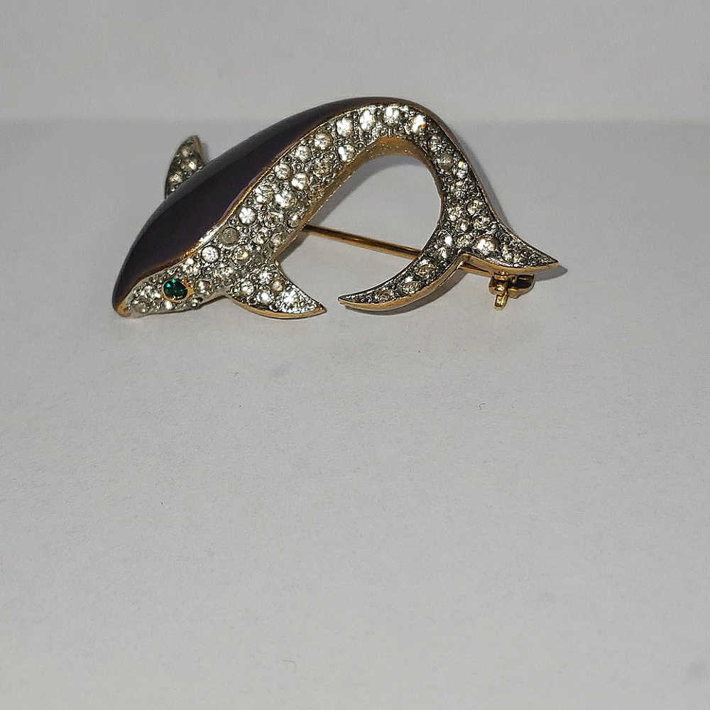A fish brooch with purple and bedazzles